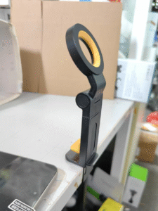 CH21 foldable magnetic phone holder side profile shot, black body with yellow accent ring