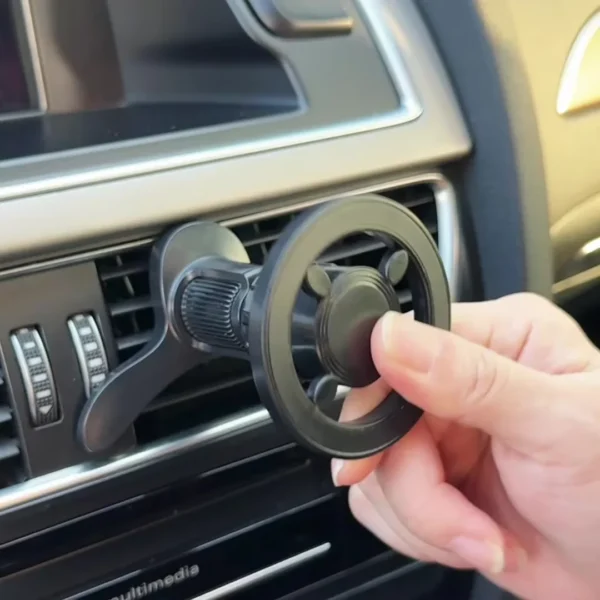 Hand installing magnetic air vent car phone holder onto vehicle air vent